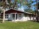 Ranch style home with red roof and large yard at 506 Kenwood Ave, Nokomis, FL 34275