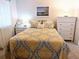 Comfortable bedroom with dresser and yellow bedding at 5581 Linksman Pl, North Port, FL 34287