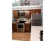 Updated kitchen with stainless steel appliances and wood cabinets at 5581 Linksman Pl, North Port, FL 34287
