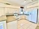 Spacious kitchen with ample counter space and white appliances at 25 Windsor Dr, Englewood, FL 34223