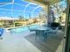 Inviting screened-in pool area with patio furniture at 25 Windsor Dr, Englewood, FL 34223