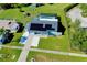 Aerial view of a house with solar panels, pool, and driveway at 4625 Pan American Blvd, North Port, FL 34287