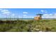 Beachfront property with lifeguard stand and grassy dunes at 4625 Pan American Blvd, North Port, FL 34287