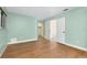 Bedroom with wood-look floors, light walls, and double doors at 4625 Pan American Blvd, North Port, FL 34287