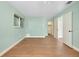 Bedroom with wood-look floors, light walls, and double doors at 4625 Pan American Blvd, North Port, FL 34287