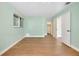 Bedroom with wood-look floors, light walls, and double doors at 4625 Pan American Blvd, North Port, FL 34287