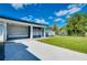 Home exterior showcasing a light blue color, screened patio, and paved walkway at 4625 Pan American Blvd, North Port, FL 34287