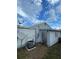 Rear exterior view of the home with AC unit and satellite dish at 4625 Pan American Blvd, North Port, FL 34287