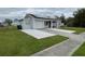 One-story home with solar panels, attached garage, and landscaped lawn at 4625 Pan American Blvd, North Port, FL 34287