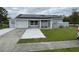 One-story home with solar panels, attached garage, and landscaped lawn at 4625 Pan American Blvd, North Port, FL 34287