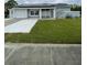 One-story home with solar panels, attached garage, and landscaped lawn at 4625 Pan American Blvd, North Port, FL 34287