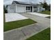 One-story home with solar panels, attached garage, and landscaped lawn at 4625 Pan American Blvd, North Port, FL 34287