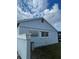 Side view of the house showing a light blue exterior and window at 4625 Pan American Blvd, North Port, FL 34287