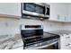 Stainless steel stove and microwave in this modern kitchen at 4625 Pan American Blvd, North Port, FL 34287