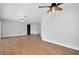 Spacious living room with wood-look floors and ceiling fan at 4625 Pan American Blvd, North Port, FL 34287