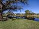 Peaceful waterfront view with lush greenery and homes in the background at 885 Country Club Cir # 61, Venice, FL 34293