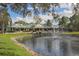 Community clubhouse near pond with fountain; resort amenities! at 885 Country Club Cir # 61, Venice, FL 34293