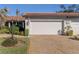 Attached garage with double doors and driveway at 885 Country Club Cir # 61, Venice, FL 34293