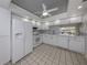 Bright white kitchen with stainless steel appliances and gray backsplash at 885 Country Club Cir # 61, Venice, FL 34293