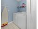 Bright laundry room with washer, dryer, and shelving at 885 Country Club Cir # 61, Venice, FL 34293