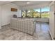 Sunlit living room with water views and tiled floors at 885 Country Club Cir # 61, Venice, FL 34293