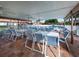 Covered patio area with tables and chairs near the pool at 885 Country Club Cir # 61, Venice, FL 34293