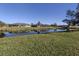 Scenic waterfront view with lush green grass at 885 Country Club Cir # 61, Venice, FL 34293