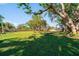 Relaxing backyard with large trees and hammock at 129 Gulf Ave, Nokomis, FL 34275