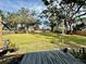 Spacious backyard with deck, lush lawn, and wooden fence at 129 Gulf Ave, Nokomis, FL 34275