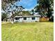Ranch-style house with grey exterior and landscaped lawn at 129 Gulf Ave, Nokomis, FL 34275