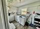 Laundry room with washer, dryer, and ample shelving at 129 Gulf Ave, Nokomis, FL 34275