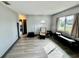 Living room featuring light grey walls, wood-look floors, and a comfy armchair at 129 Gulf Ave, Nokomis, FL 34275