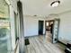 Sunroom with wood-look floors and access to the backyard at 129 Gulf Ave, Nokomis, FL 34275