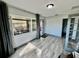 Sunroom with wood-look floors and access to the backyard at 129 Gulf Ave, Nokomis, FL 34275