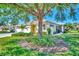Exterior of a house with a large tree and well-maintained yard at 1599 Monarch Dr # 1599, Venice, FL 34293