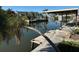 Private dock and canal access with lush tropical landscaping at 335 Palm Grove Ave, Englewood, FL 34223