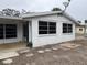 White single story home with covered entry at 335 Palm Grove Ave, Englewood, FL 34223