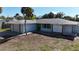 Ranch-style home with carport and mature landscaping at 335 Palm Grove Ave, Englewood, FL 34223