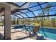 Inviting pool and spa with screened enclosure and serene views at 589 Mistiflower Cir, Nokomis, FL 34275