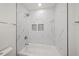 Clean bathroom with marble tile, shower, and bathtub at 606 Marcus St # 26, Venice, FL 34285
