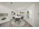 Kitchen dining area with round table and four grey chairs at 606 Marcus St # 26, Venice, FL 34285