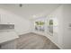 Bright dining area with large windows and wood-look flooring at 606 Marcus St # 26, Venice, FL 34285