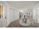 Bright entryway with glass-top table and view into the kitchen and living area at 606 Marcus St # 26, Venice, FL 34285