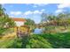Wooden footbridge over a tranquil pond, surrounded by lush greenery at 606 Marcus St # 26, Venice, FL 34285