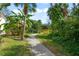 Landscaped pathway with lush tropical plants and a wooden bridge at 606 Marcus St # 26, Venice, FL 34285
