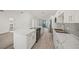 Open concept kitchen with island, white cabinets, and stainless steel appliances at 606 Marcus St # 26, Venice, FL 34285