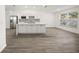 Open concept kitchen with large island, white cabinets, and stainless steel appliances at 606 Marcus St # 26, Venice, FL 34285