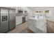 Modern kitchen island with marble countertop and stainless steel appliances at 606 Marcus St # 26, Venice, FL 34285