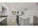 Modern kitchen with white cabinets, marble countertops, and stainless steel appliances at 606 Marcus St # 26, Venice, FL 34285