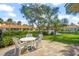 Relaxing patio area with table and chairs overlooking a pond at 606 Marcus St # 26, Venice, FL 34285